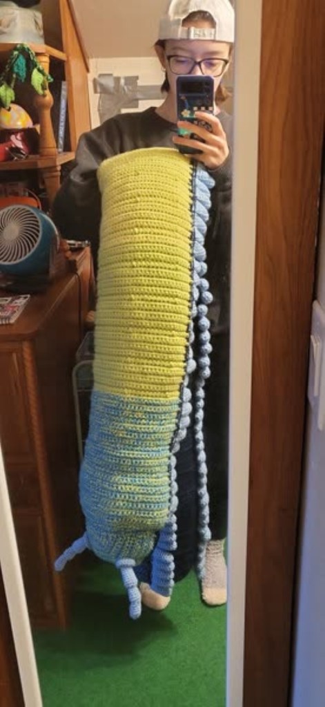 A giant blue green and yellow crochet centipede